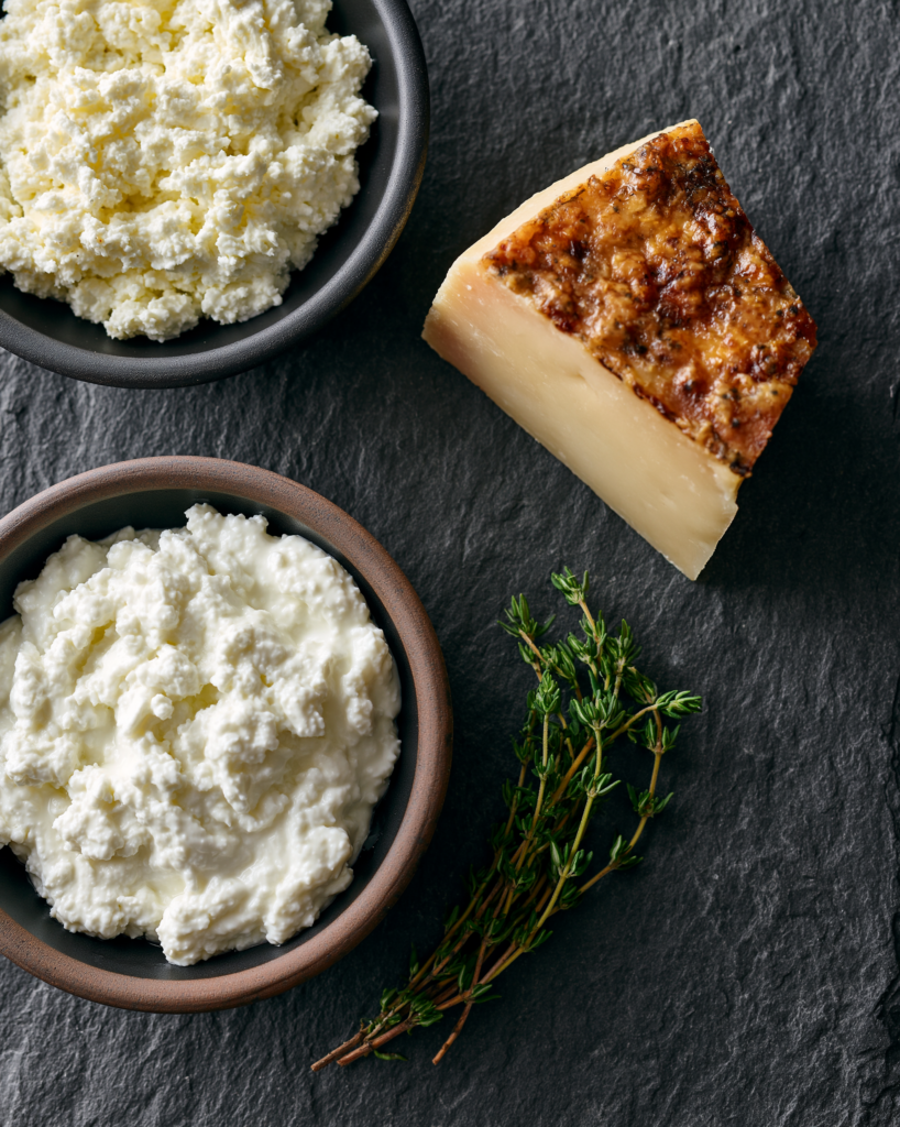 Flat lay of thyme cottage cheese chips ingredients: cottage cheese, parmesan, and fresh thyme