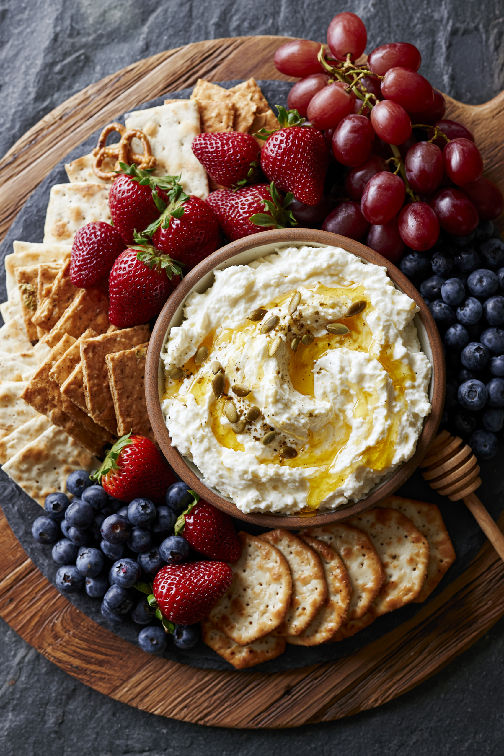 Cottage cheese snack board with whipped cottage cheese, crackers, fresh fruit, and honey, a high protein snack